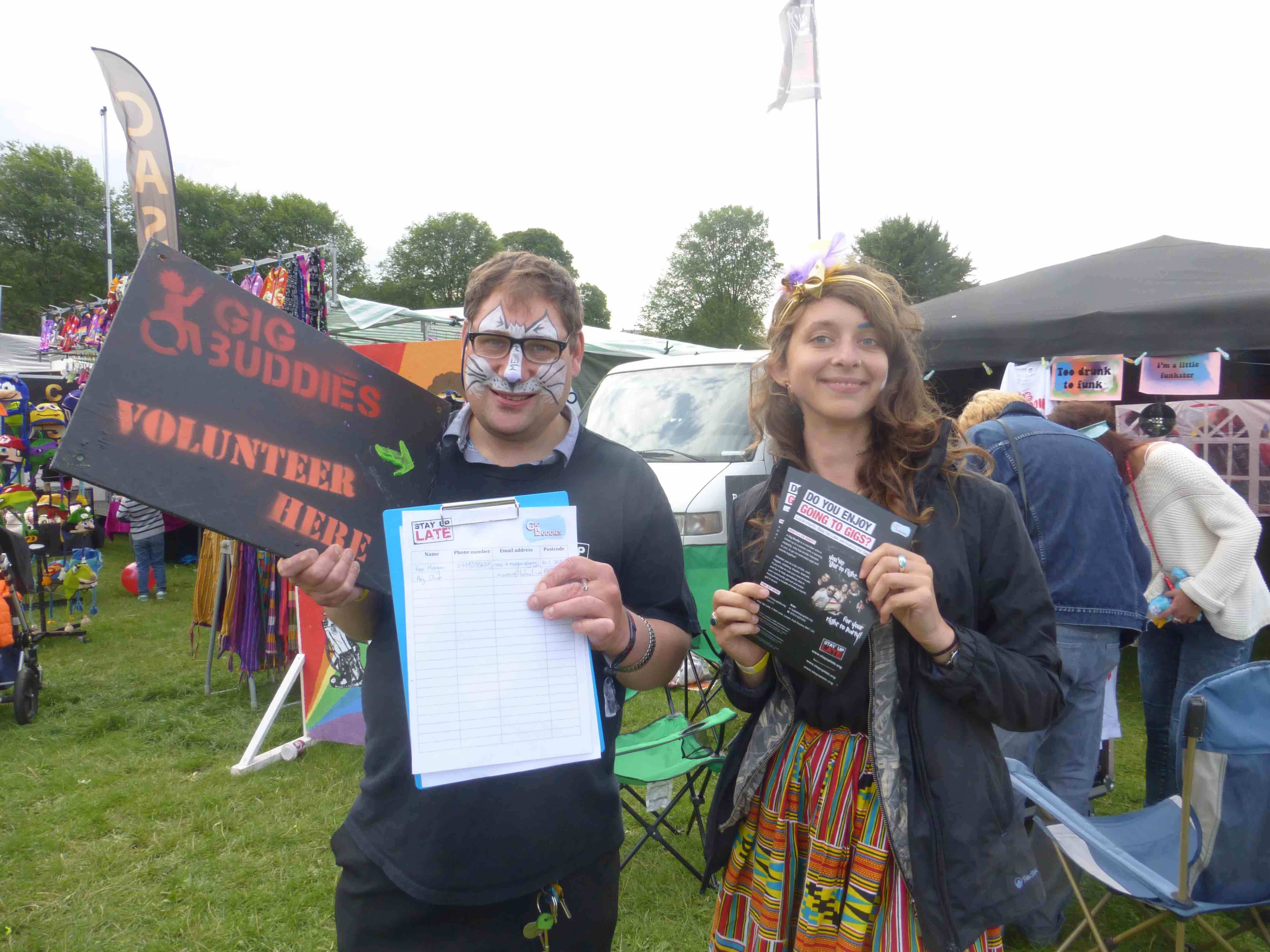 Madeline and Daniel recruiting volunteers at a festival 