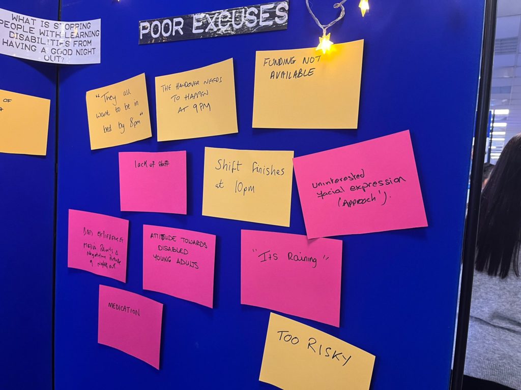 A photo of a wall with pink and yellow bricks attached to a wall with the title "Poor Excuses" above it. On each 'brick' there are excuses fro reasons not to go out with the person you support.